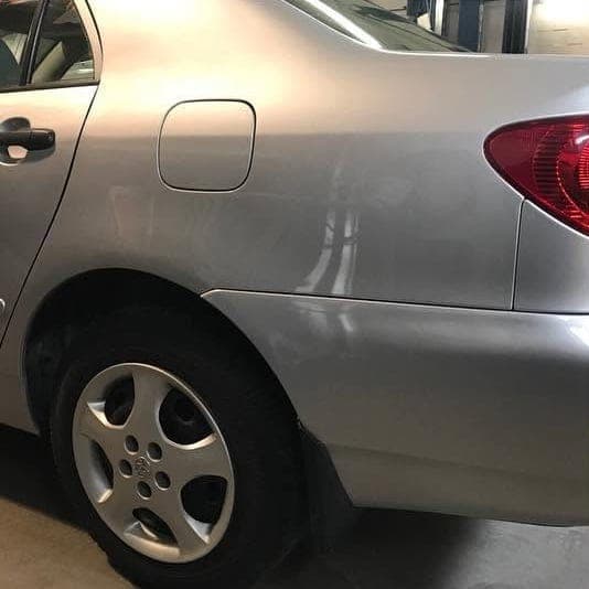 The same Corolla with the quarter panel, tail light and bumper repaired