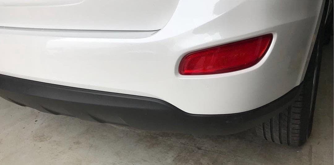 The same bumper repaired and refinished in white
